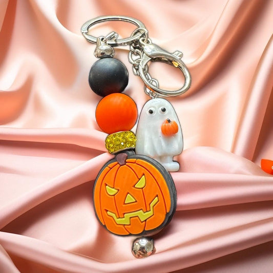 Halloween-themed keychain with pumpkin and ghost charm.