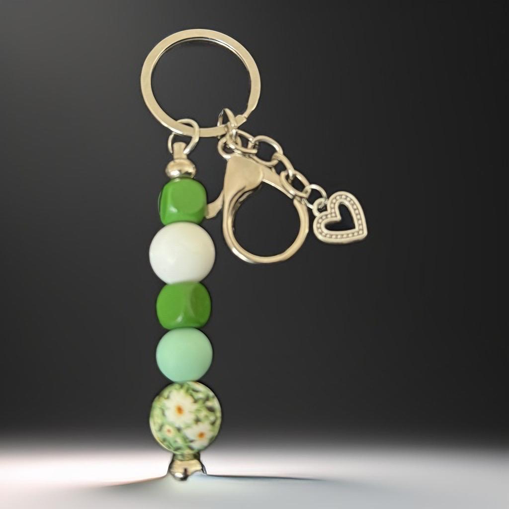 "Handmade Green Beaded Keychain with Floral & Heart Charm – Nature-Inspired Accessory"