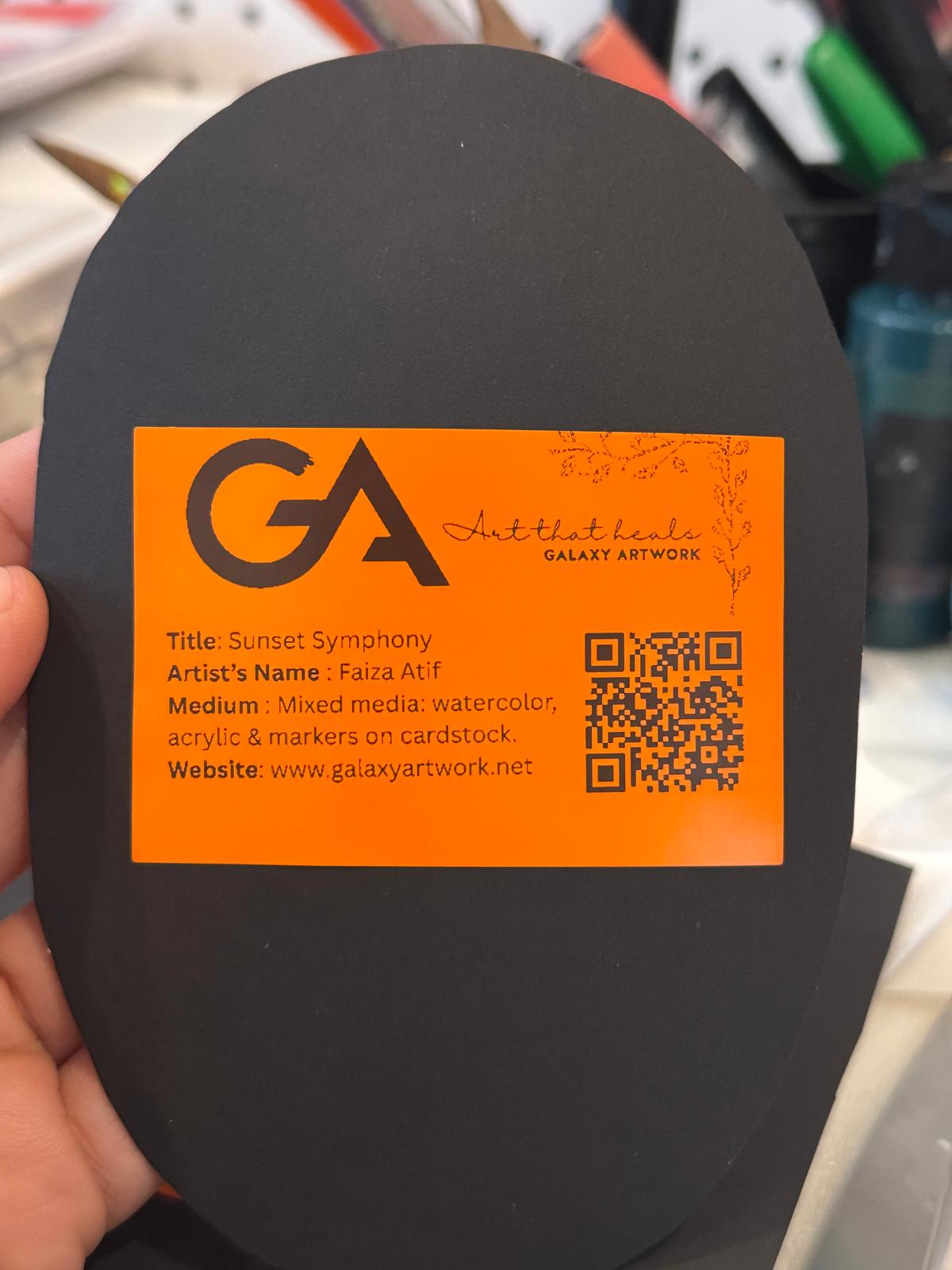 Framed painting “Sunset Symphony” by Faiza Atif – an oval mixed media artwork of sunset trees and reflections, set in a black and gold ornate frame.