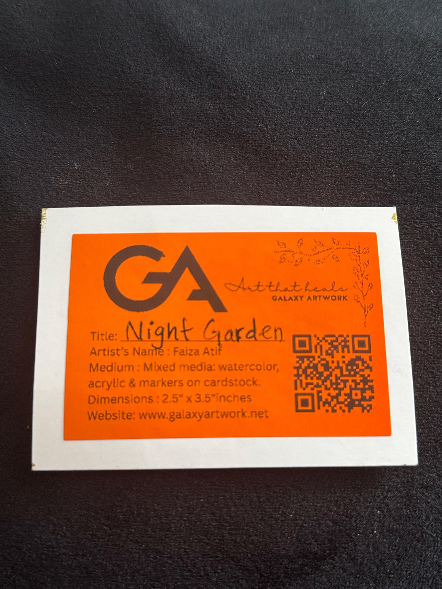 Artwork label with 'GA' logo and text on a dark background
