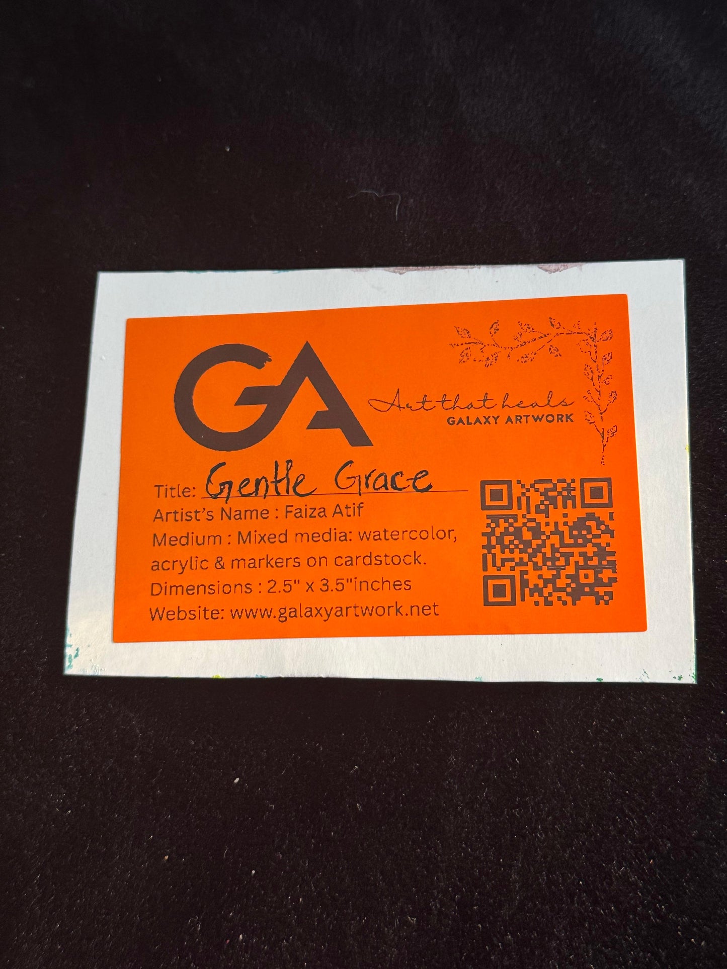 Orange business card with black text on a dark background