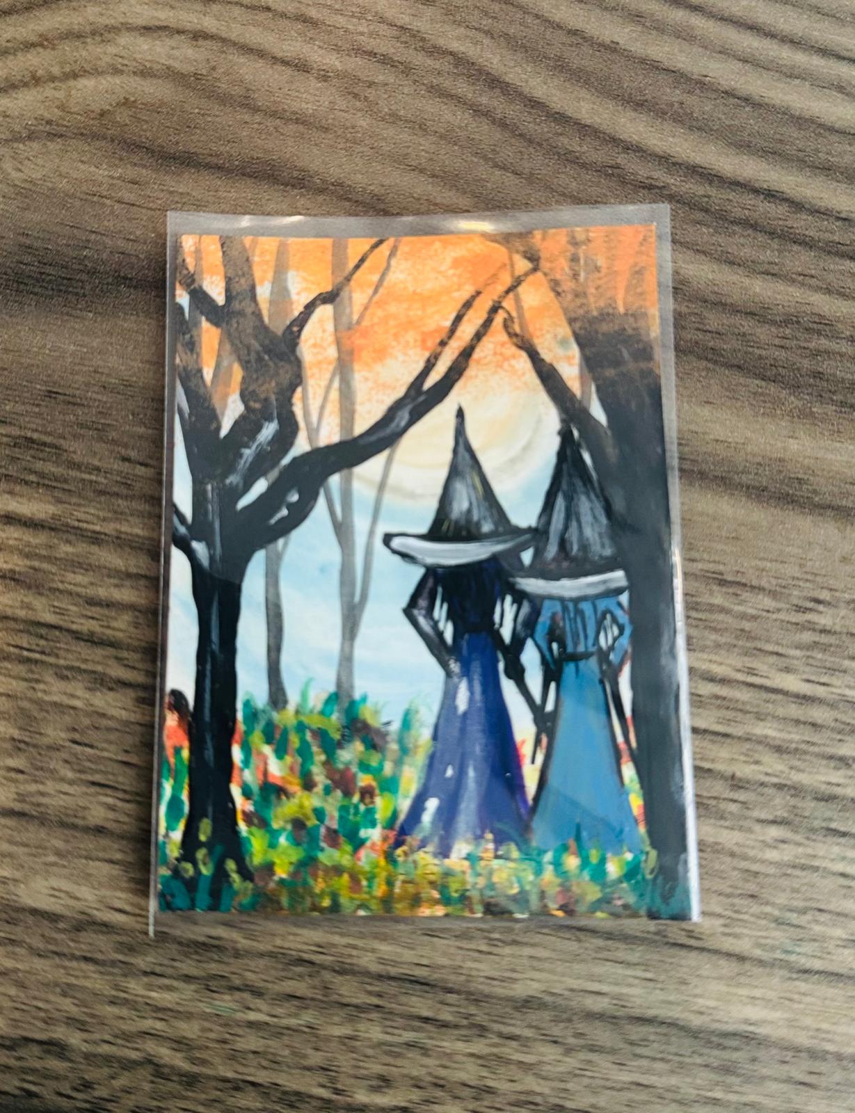 Artistic depiction of a witch in a blue dress and black hat in a forest setting with trees and a sunset.