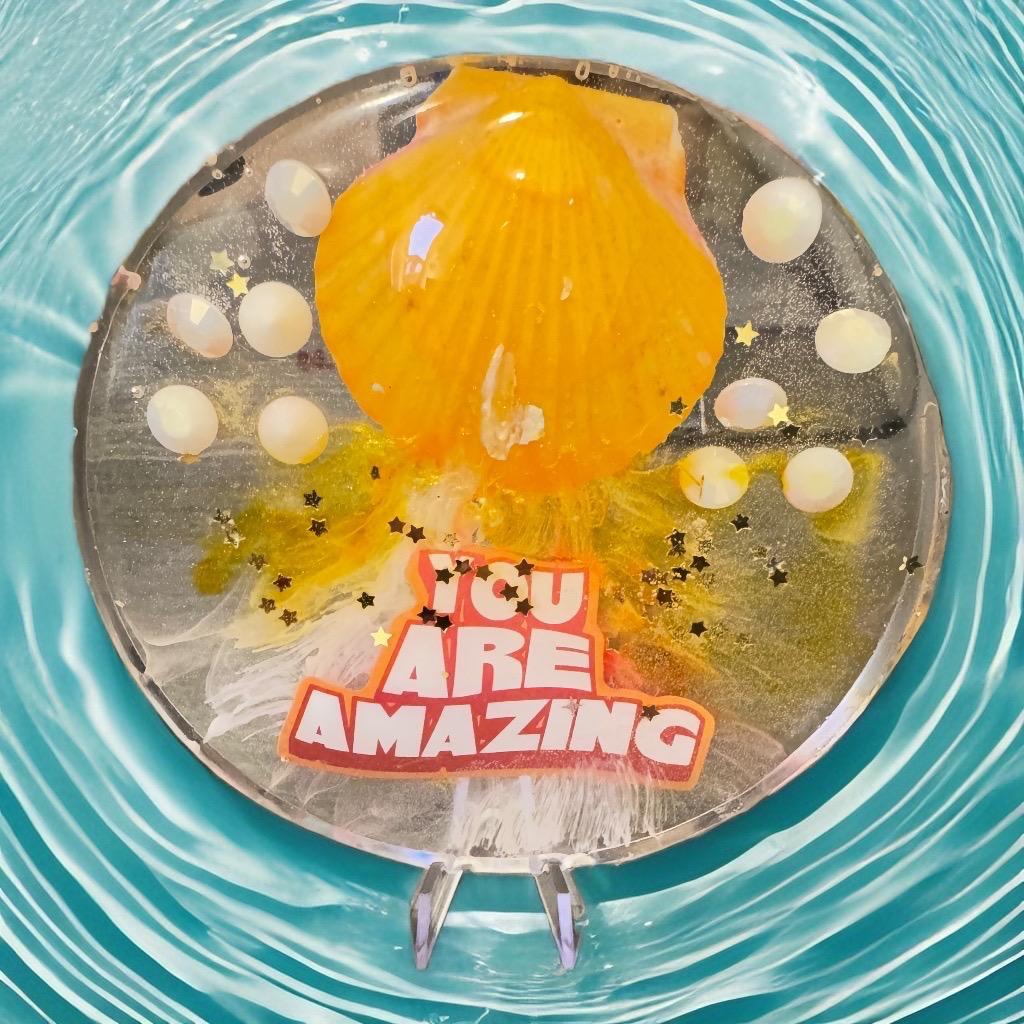 Handmade resin display plate with bold orange seashell, golden stars, and “You Are Amazing” quote – an inspirational gift and decorative art piece.