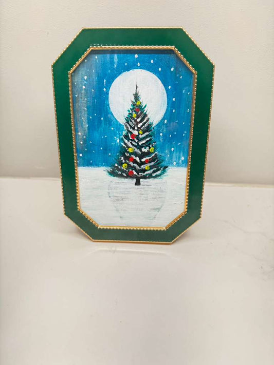 Handmade mini acrylic painting of a Christmas tree under a full moon in a green frame