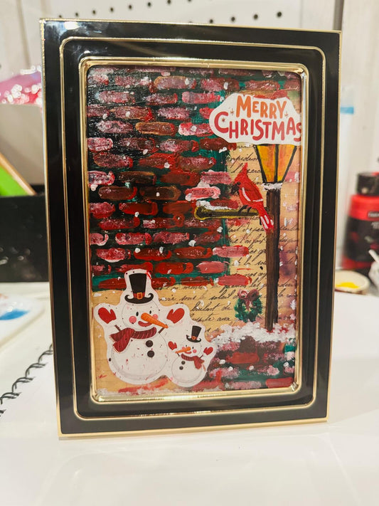 Christmas-themed original painting with snowmen and 'Merry Christmas' text, framed in black.