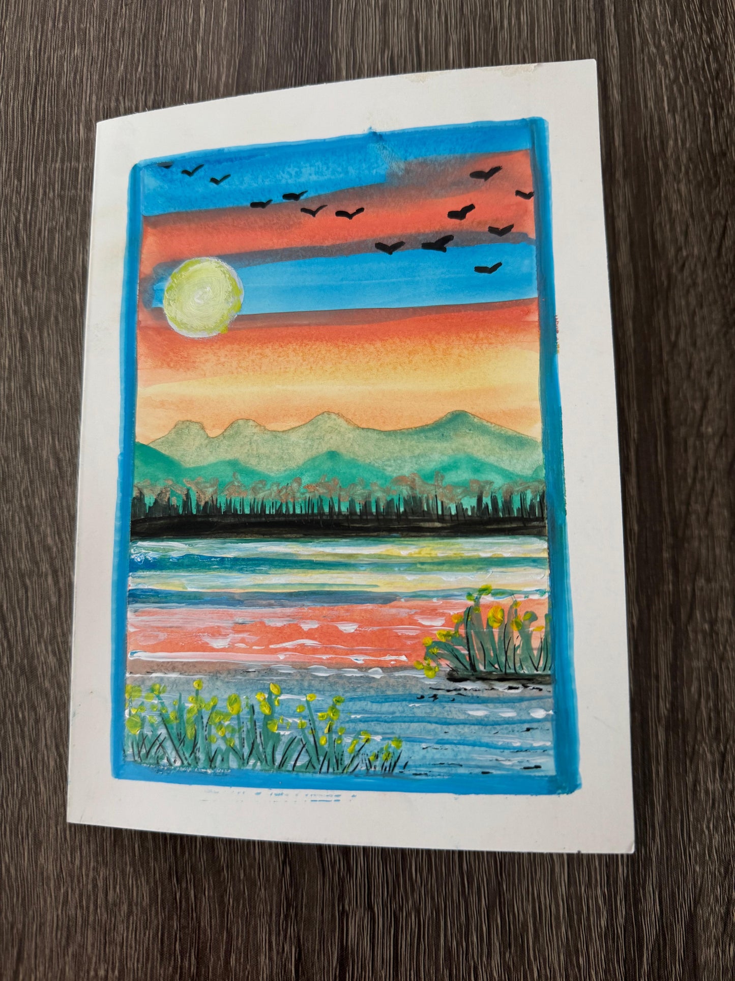 Artistic depiction of a sunset over water with mountains and birds.