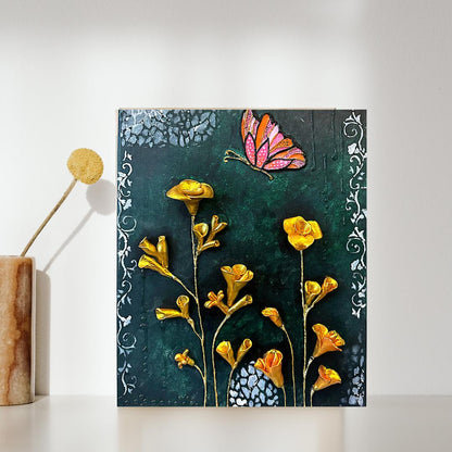 Decorative wall art with yellow flowers and a butterfly on a dark green background.