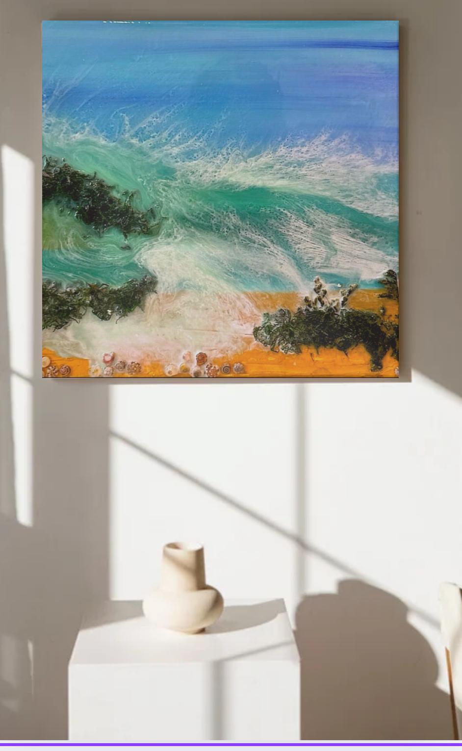 Textured resin painting of a crashing wave on the beach with natural materials.