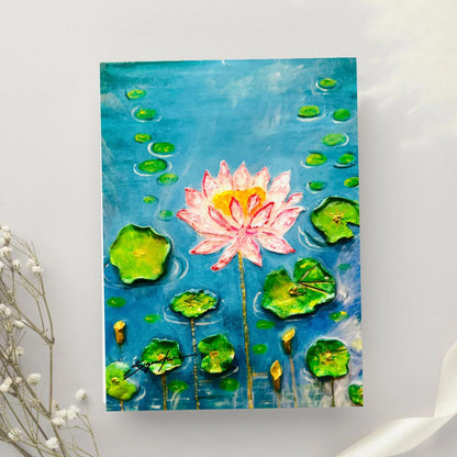 Handcrafted 3D lotus flower painting featuring a pink lotus bloom, raised green lily pads, and a glossy resin finish on a blue water background, 11x14 inches.