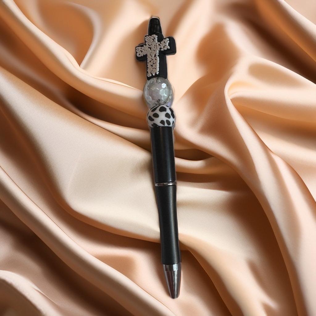 Black pen with cross charm and white patterned bead, elegant spooky-themed beaded pen for Halloween.