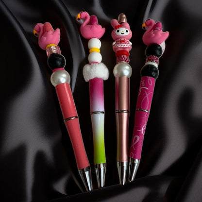 Four decorative pens with flamingo and cartoon character .