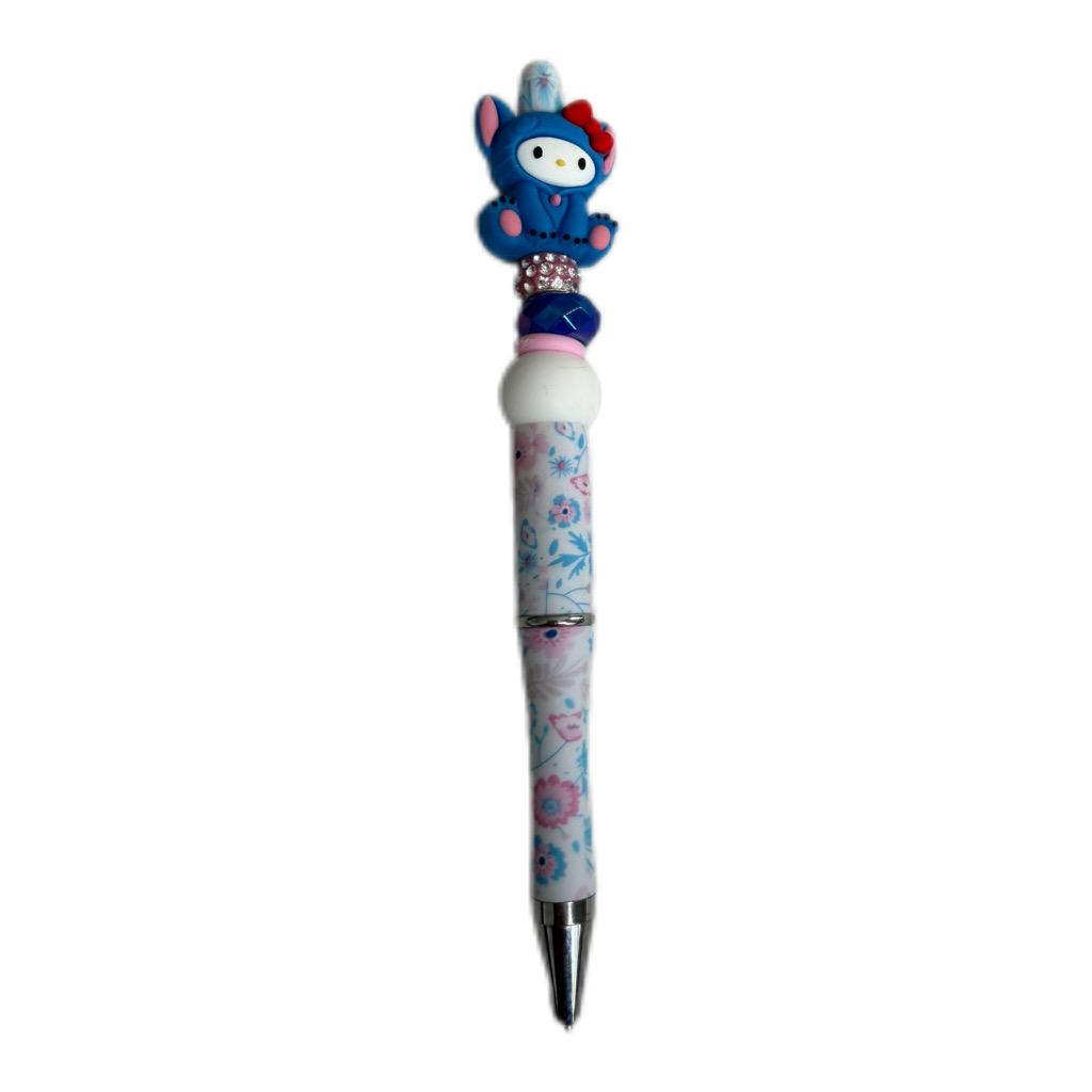 Handmade blue bunny beaded pen with character topper, decorative beads, and floral-patterned ballpoint pen body.