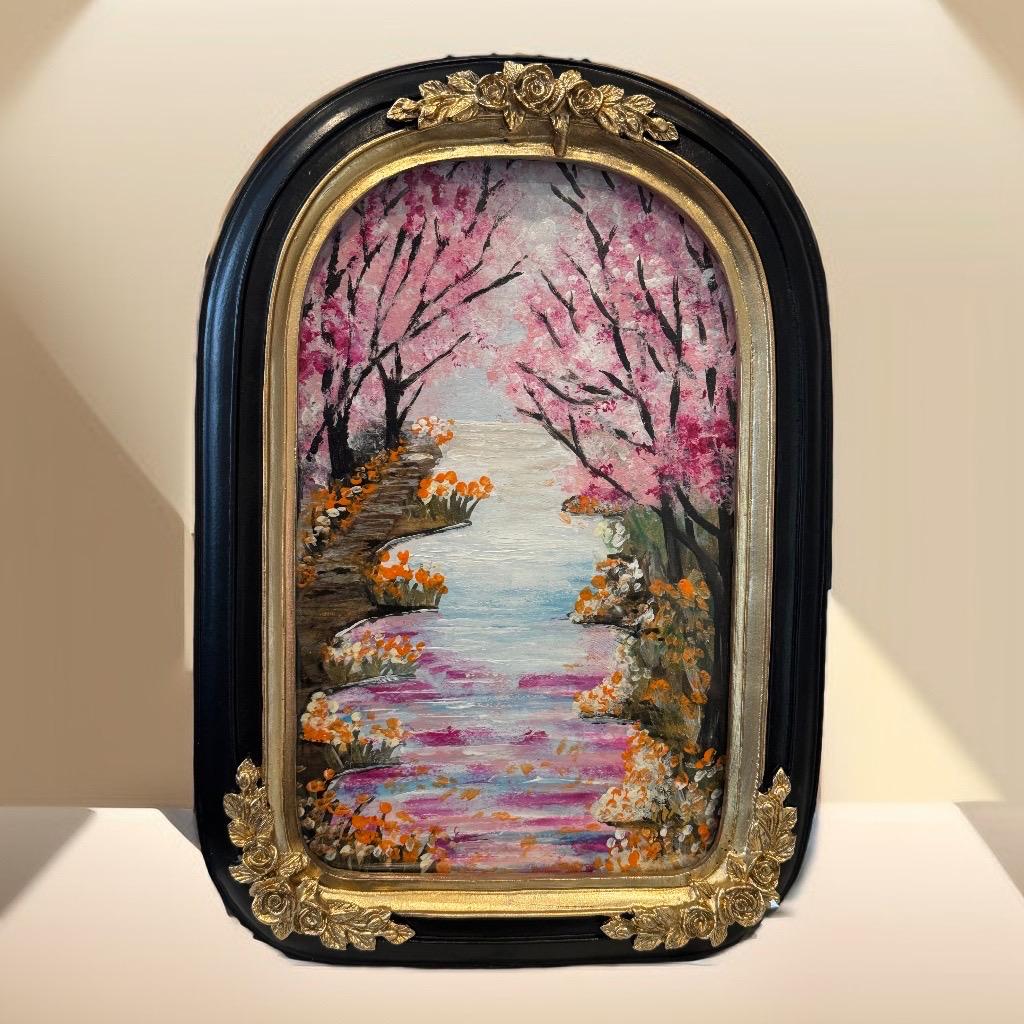 Decorative painting of a cherry blossom garden with a black and gold frame.