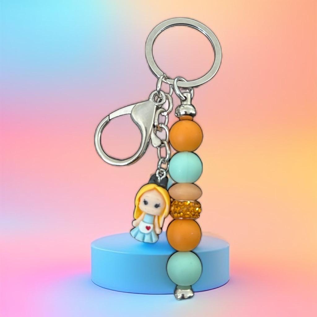 Handmade Beaded Keychain with Cute Doll Charm – Pastel & Gold Accent Design"