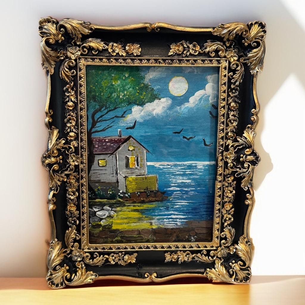 Moonlit Reflections framed painting – moonlit cottage by water with birds and tree in ornate golden frame