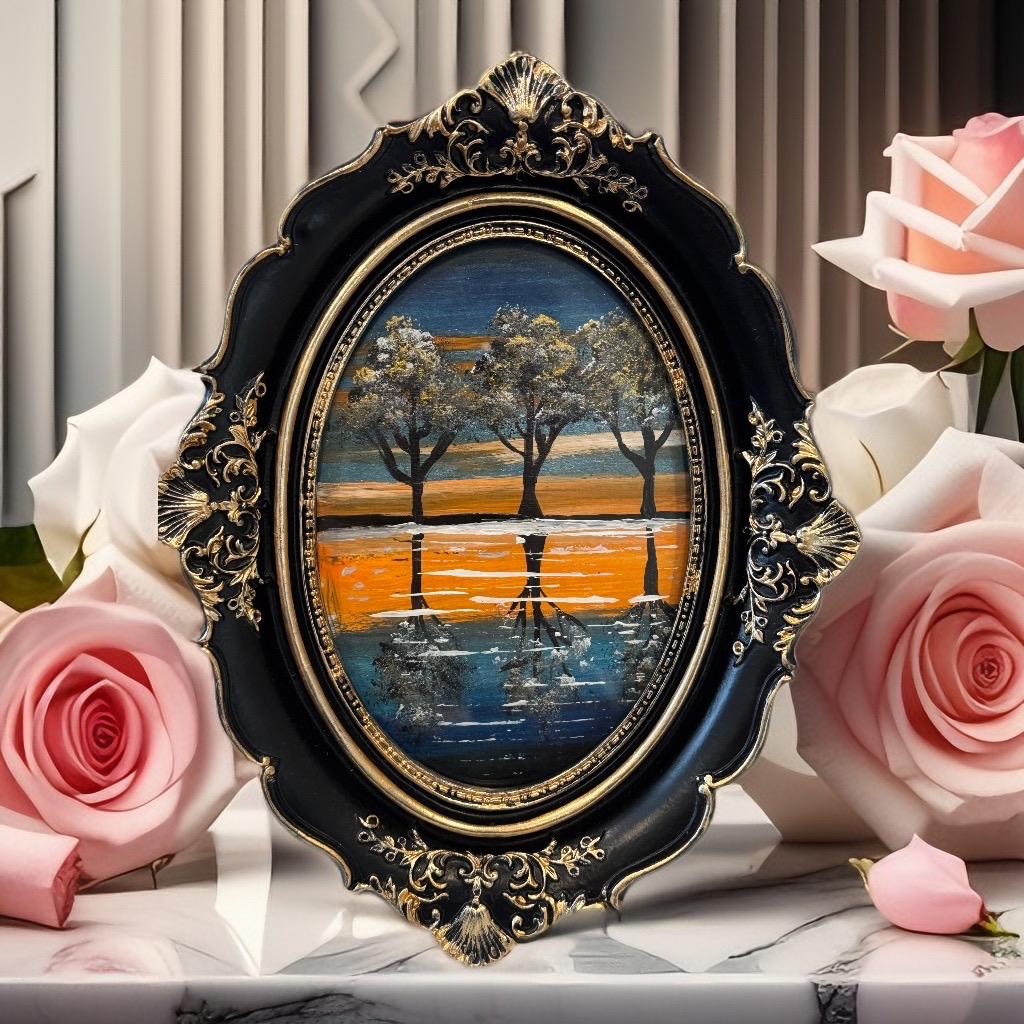 Framed painting “Sunset Symphony” by Faiza Atif – an oval mixed media artwork of sunset trees and reflections, set in a black and gold ornate frame.