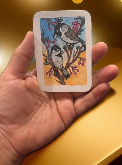 Hand-painted ACEO mini art card featuring two brown and black birds on a branch with red berries against a warm sky background.
