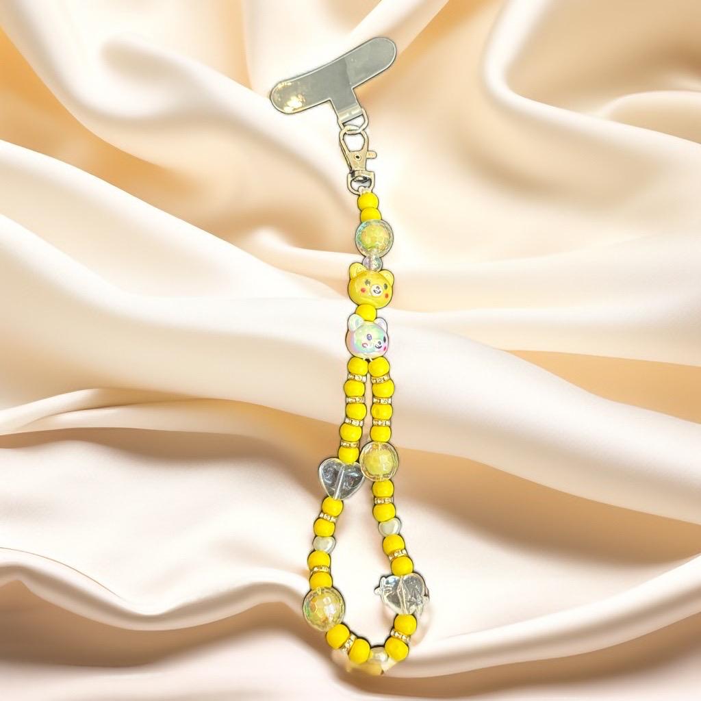 Handmade beaded mobile charm in soft  tones with bear, butterfly, and flower beads, finished with clear crystal accents, by Galaxy Artwork.