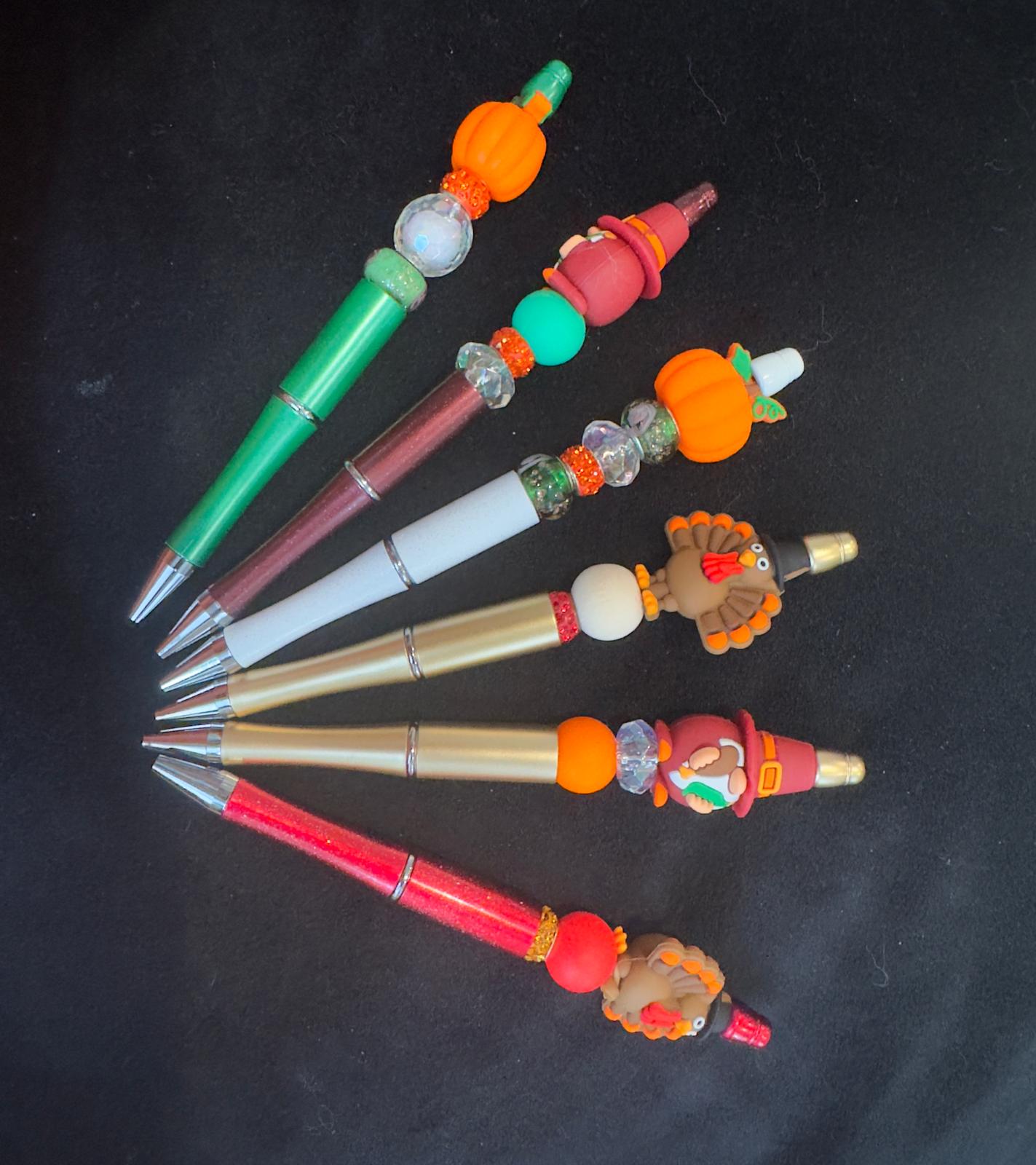 Colorful pens with decorative ends for thanks giving theme.