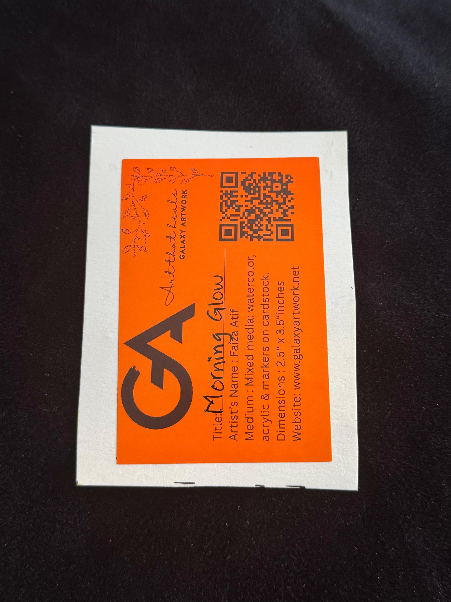 Orange and white business card with a QR code and text on a black background