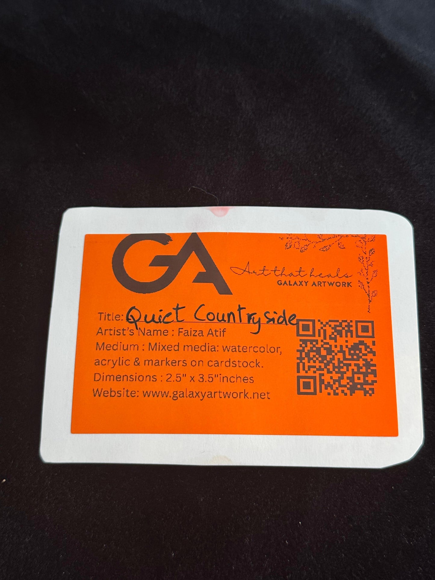 Orange and white label with 'GA' logo and text on a dark background