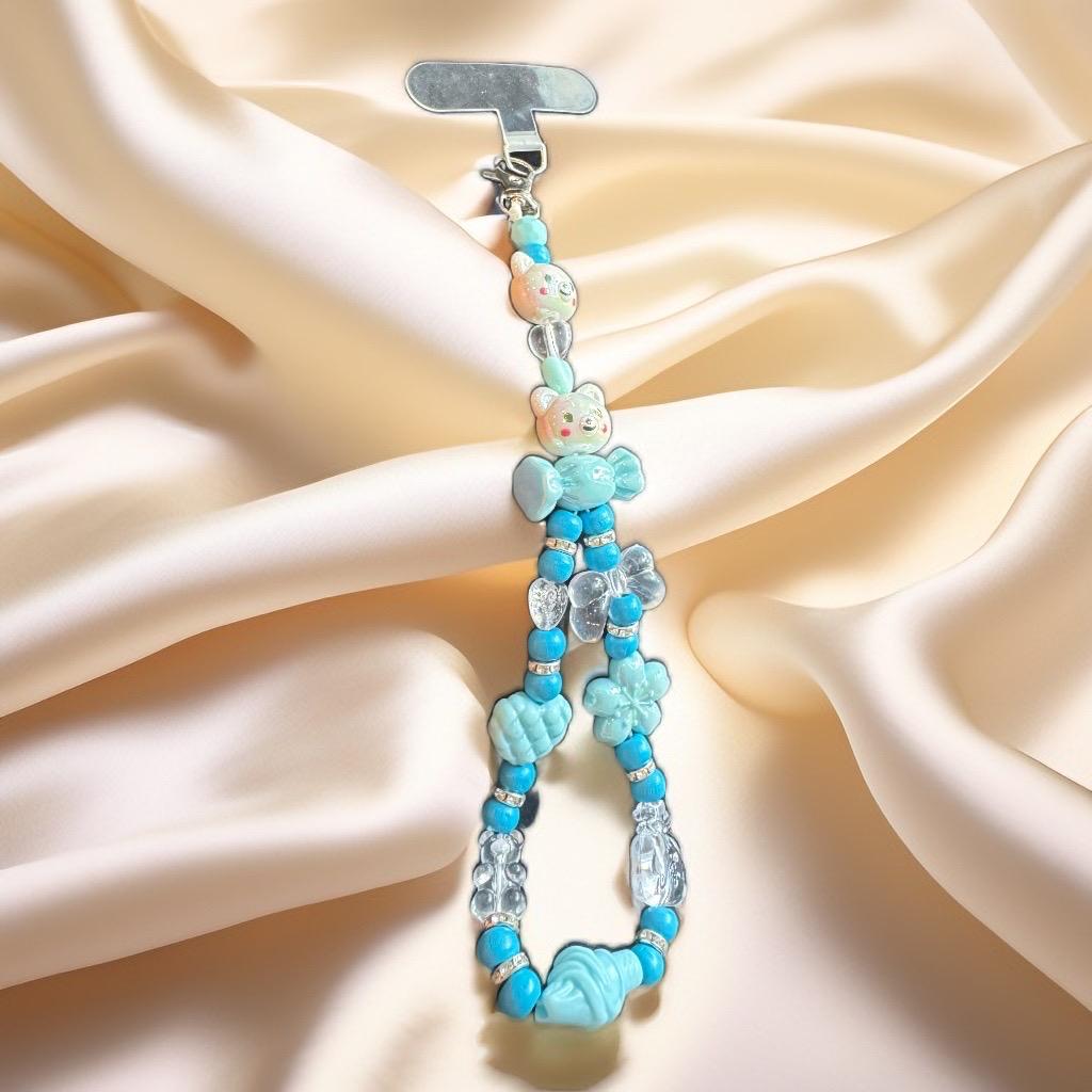 Beaded keychain with teddy bear charms .