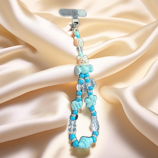 Beaded keychain with teddy bear charms .