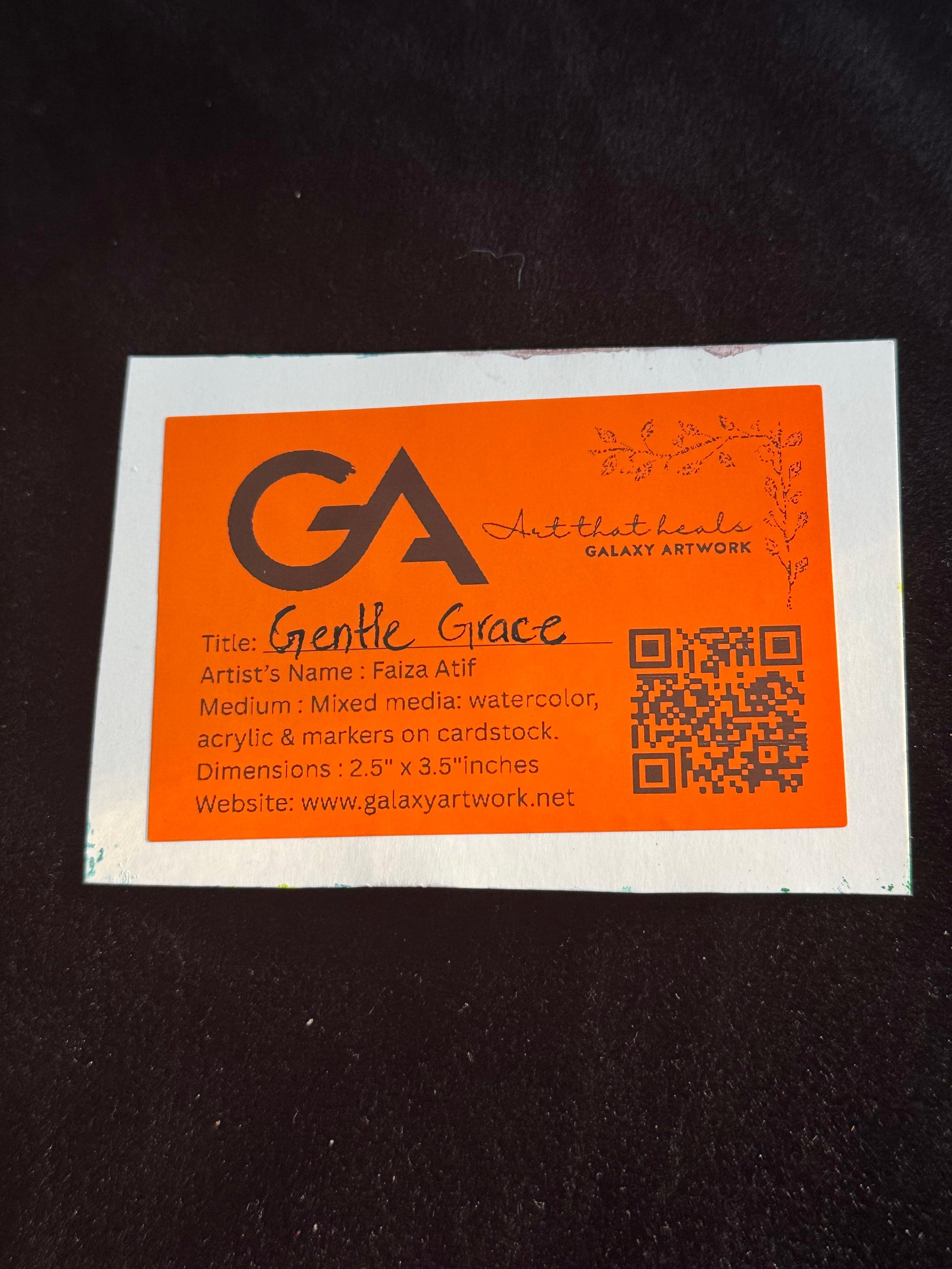 Orange business card with black text on a dark background