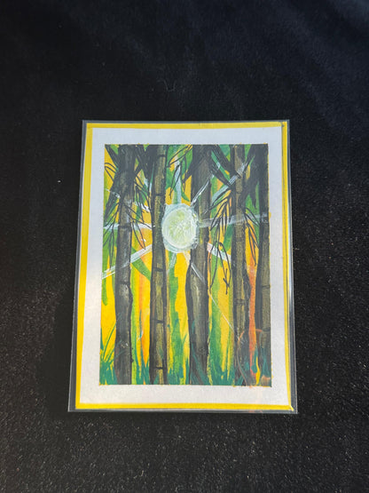 “Mini bamboo forest painting with tall dark stalks, bright yellow-orange sky, and a glowing white moon shining through.