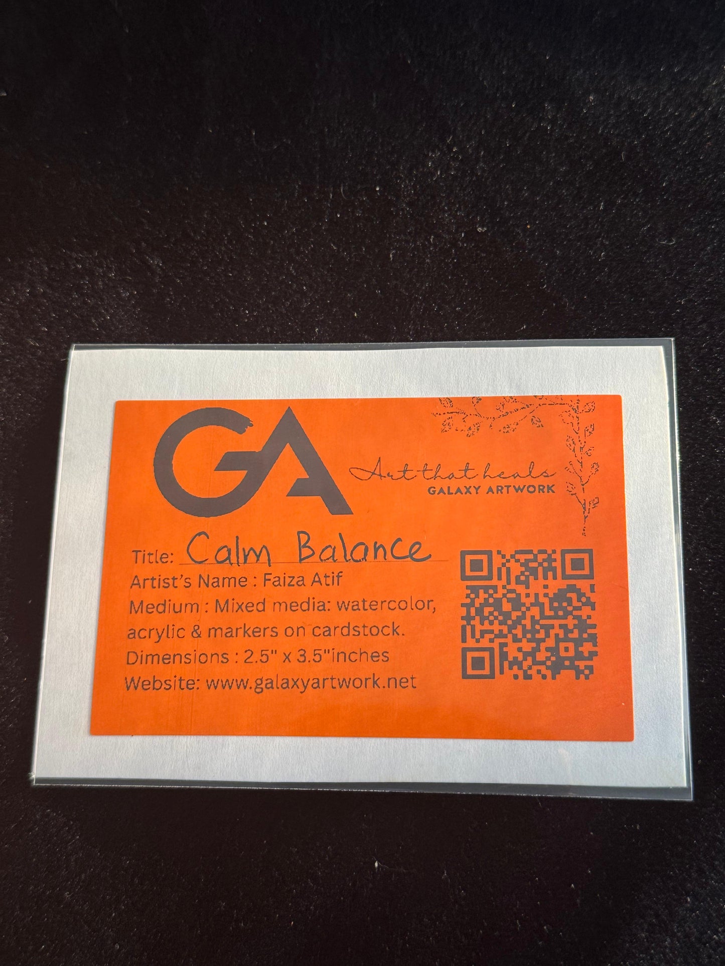 Orange art card with 'GA' logo and text on a black background