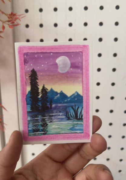 Hand-painted ACEO card of moonrise over mountains with pink and yellow twilight.