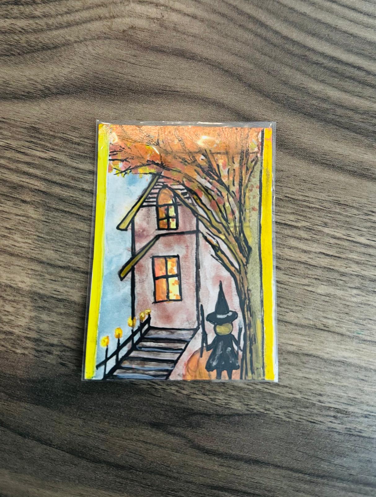 ACEO of a house with a witch on a broomstick.