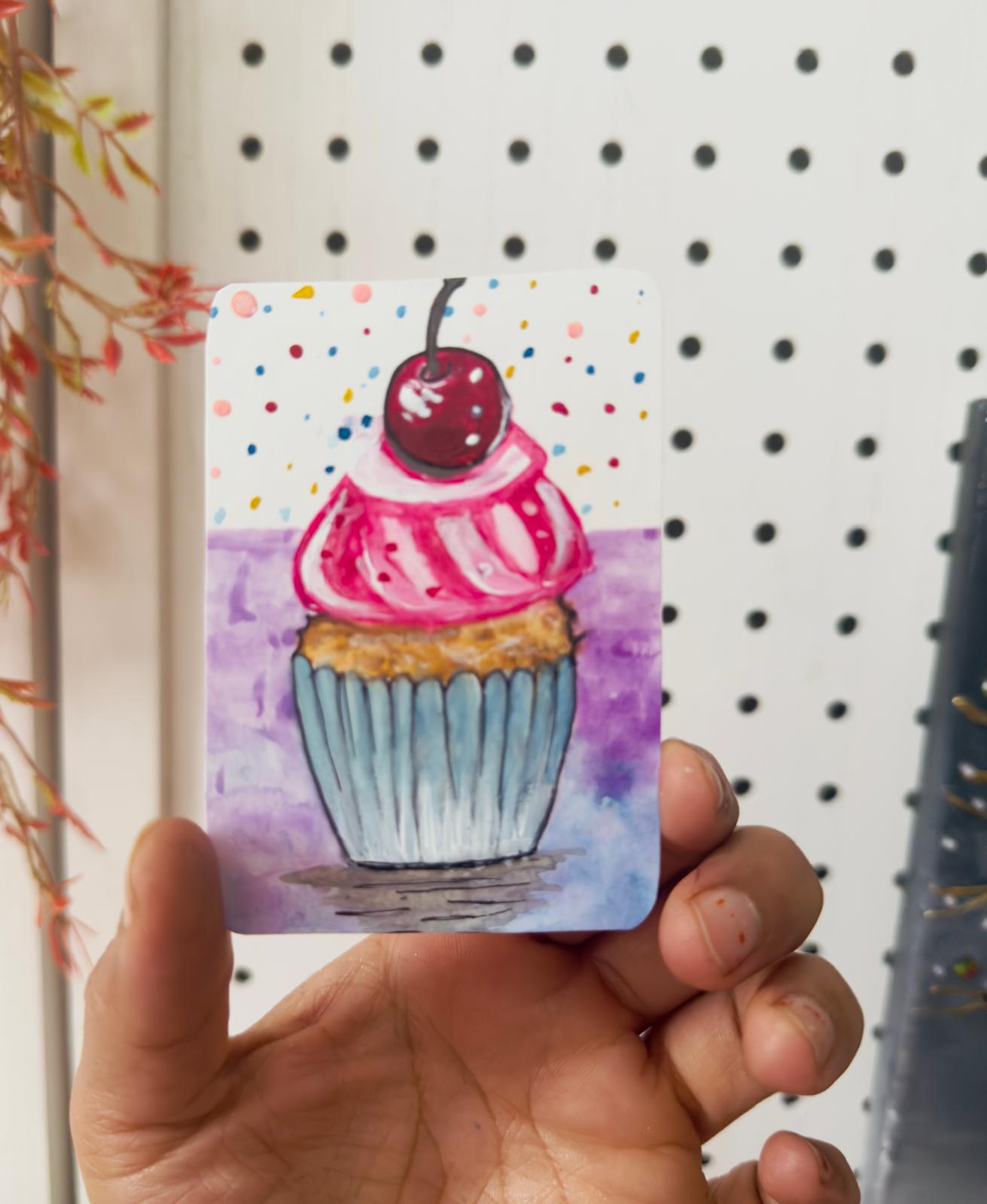 Hand-painted ACEO card of cupcake with pink frosting, cherry, and sprinkles.