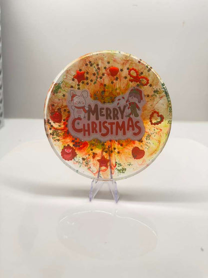 Decorative resin coaster/plate with 'Merry Christmas' text and festive design surface..
