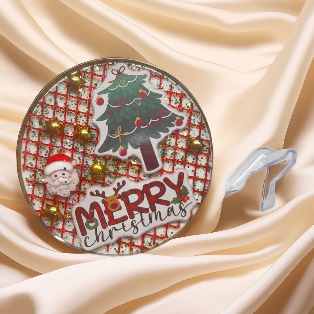 Handmade Christmas resin coaster with warm orange flowers, glitter, and Merry Christmas sticker.
