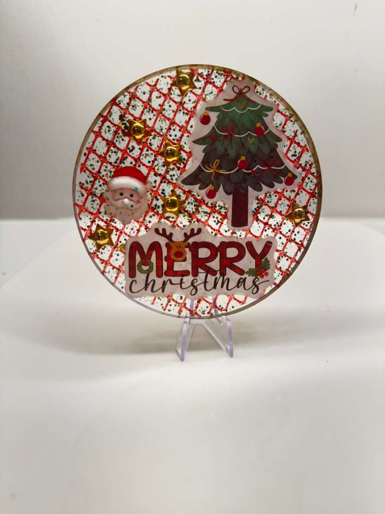Christmas resin coaster with Santa face, Christmas tree sticker, red glitter pattern, and gold star accents.