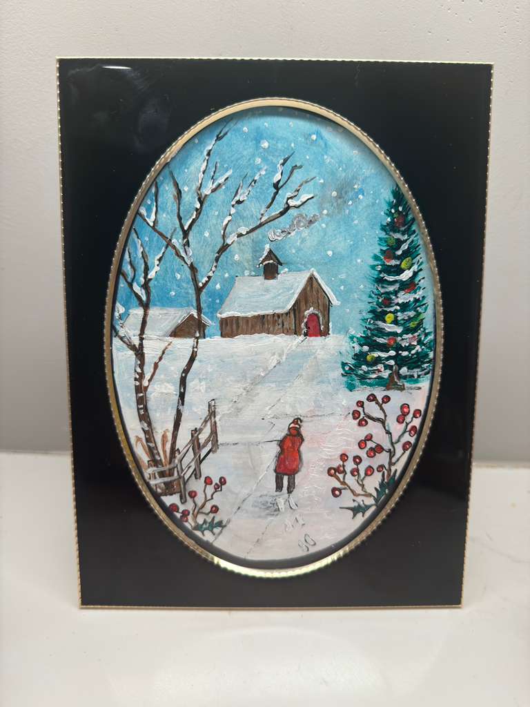 Winter scene with a house, tree, and person in a red coat on a black border