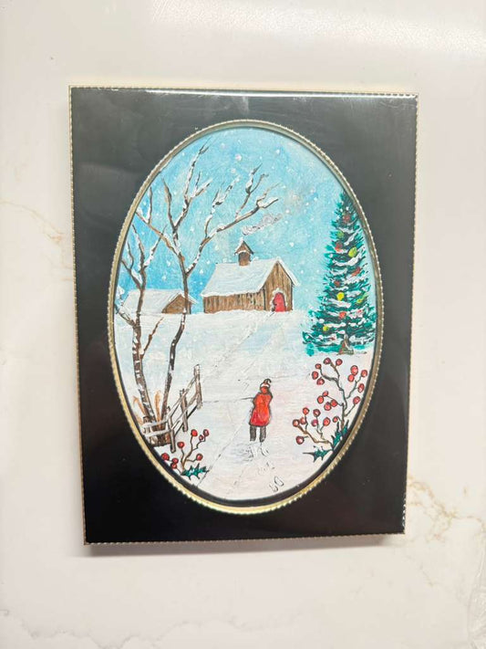 Winter scene with a house, tree, and person in a red coat on a decorative card.