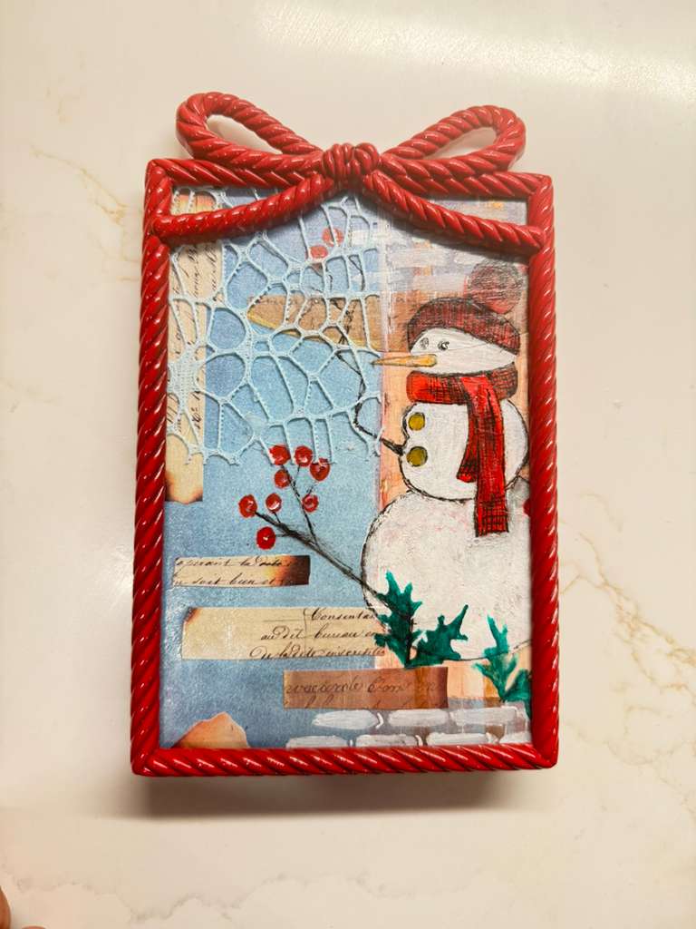 Snowman original painting in red metal frame.
