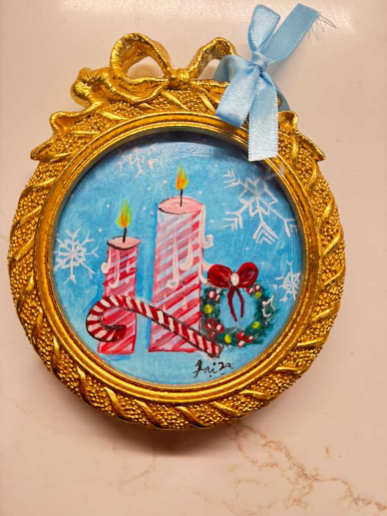 Handmade mini acrylic painting of two striped candles, a wreath, and a candy cane in a round gold frame with a blue ribbon.