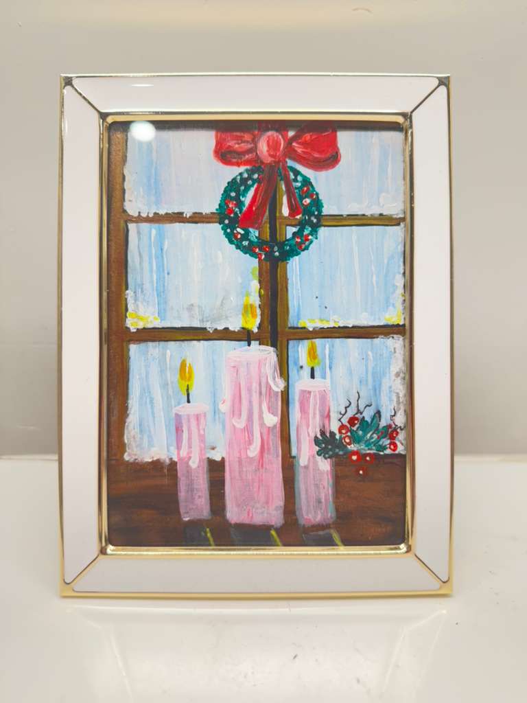 Handmade mini acrylic painting of pink candles glowing on a windowsill with a Christmas wreath and winter background.