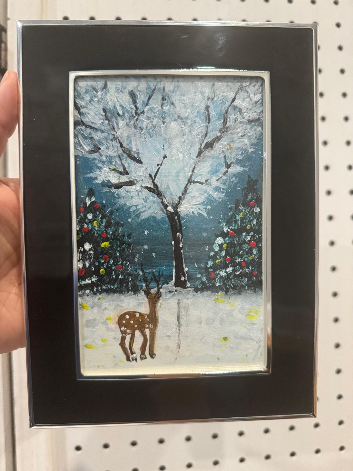 Framed artwork of a deer in a snowy landscape with trees. Handmade art.