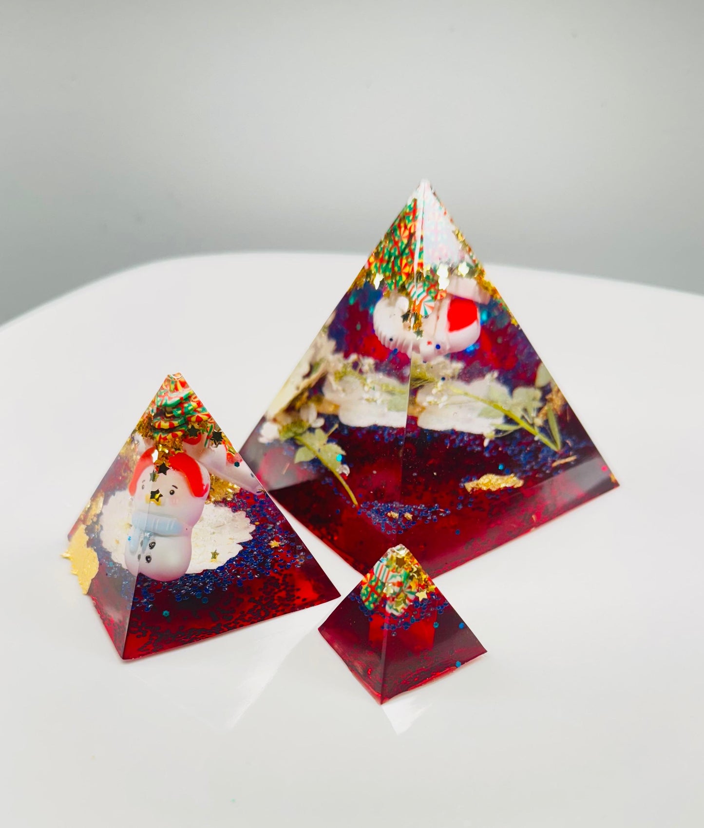 Triangular resin pieces with embedded snowmen.