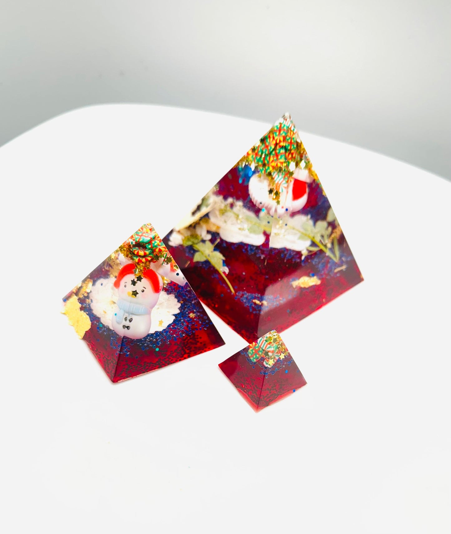 Triangular resin pieces with embedded snowmen.