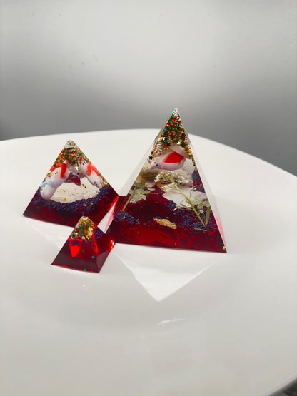 Triangular resin pieces with embedded snowmen.
