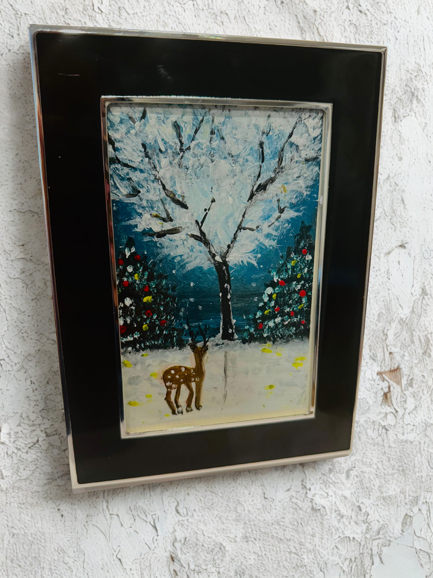 Framed artwork of a deer in a snowy landscape with trees. Handmade art.