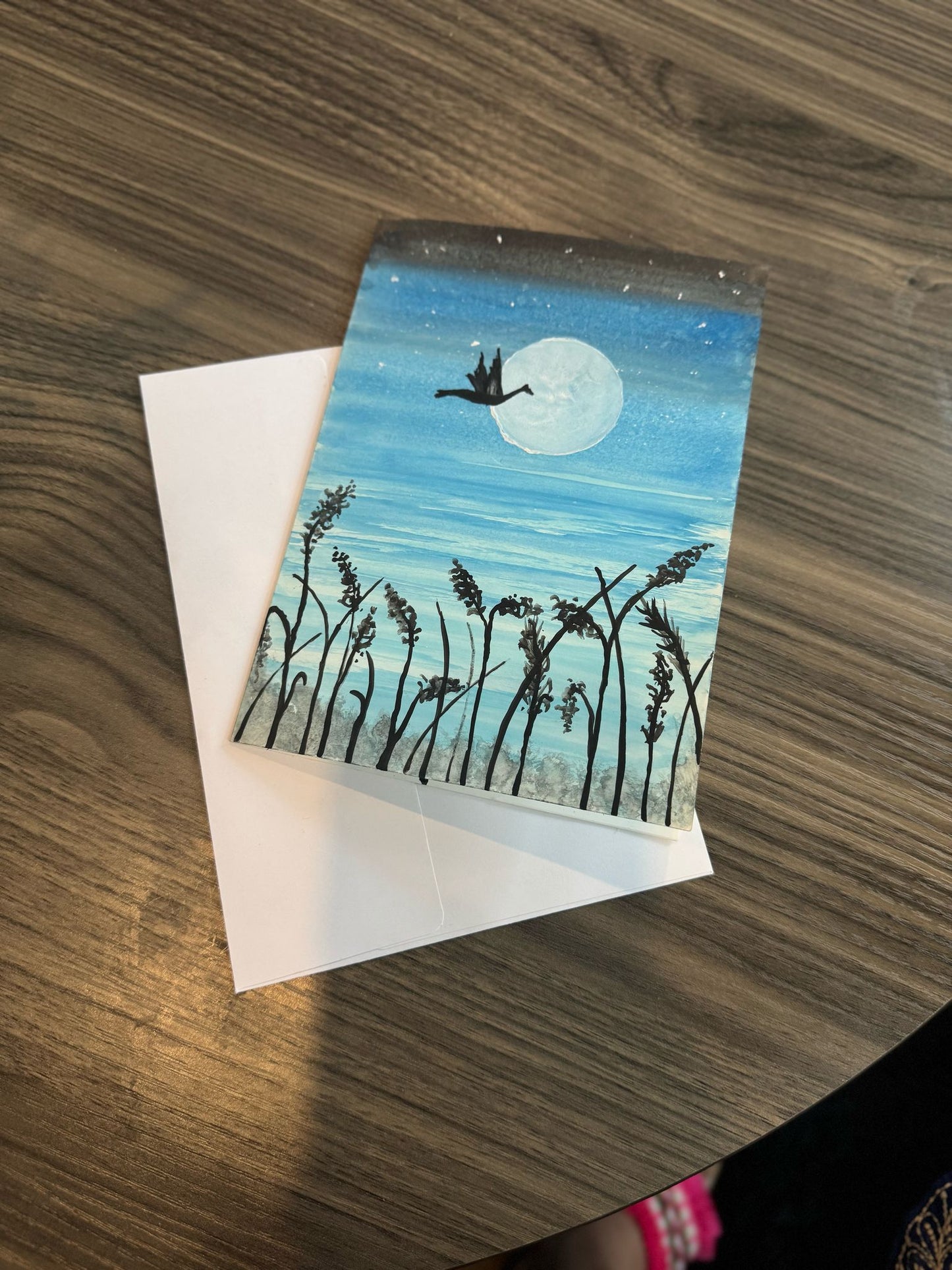 Greeting card with a duck and moon design .