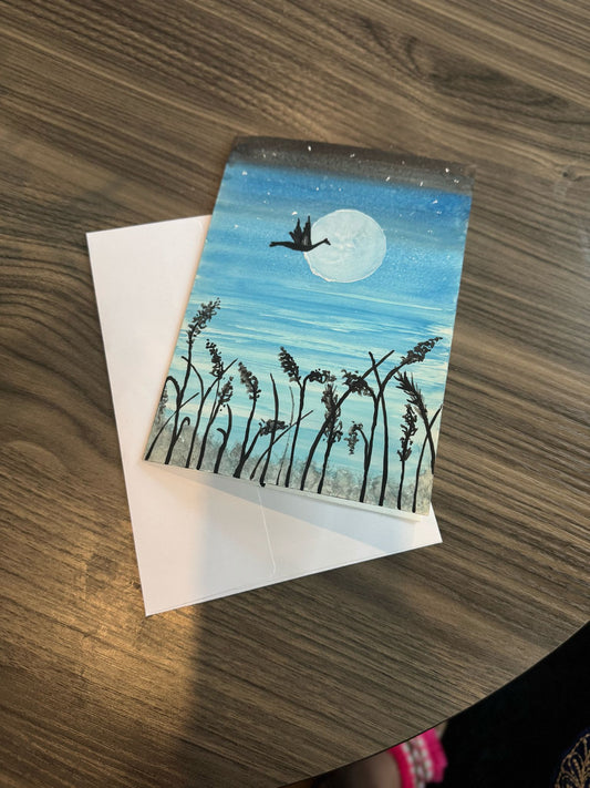 Greeting card with a duck and moon design .