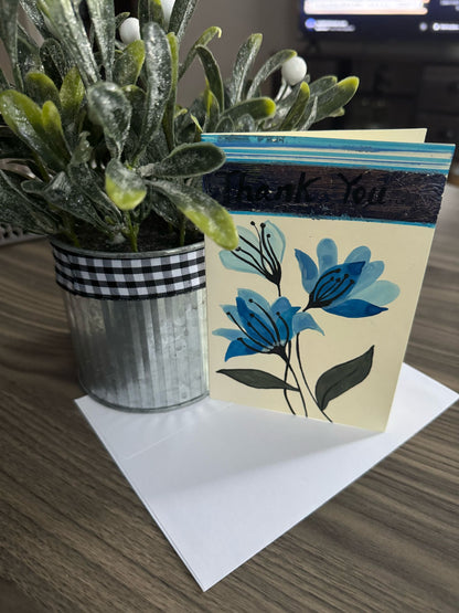 Hand painted 'Thank You' card featuring blue flowers.