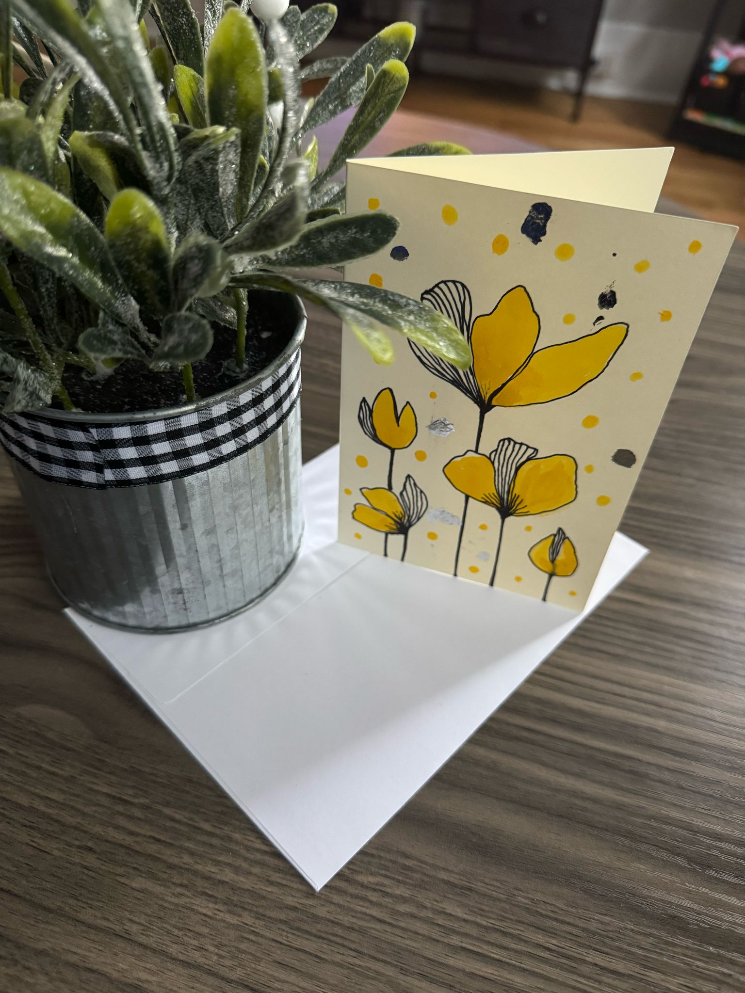 Card with yellow floral design .